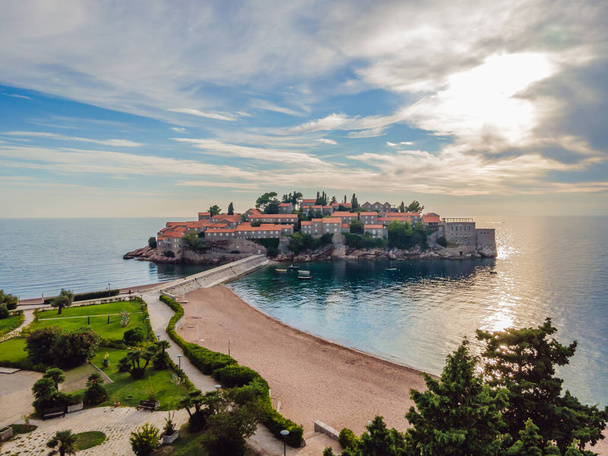 Aerophotography. View from flying drone. Panoramic view of Sveti Stefan island in Budva in a beautiful summer day, Montenegro. Top View. Beautiful destinations - Foto, Imagem