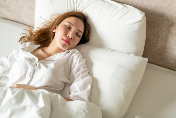 portrait beautiful Asian woman sleeping on bed with white pillow - Photo, Image