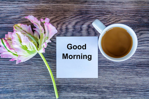 Cup of Coffee with Good Morning Message and Pink Tulip Flower .Top view - Fotografie, Obrázek