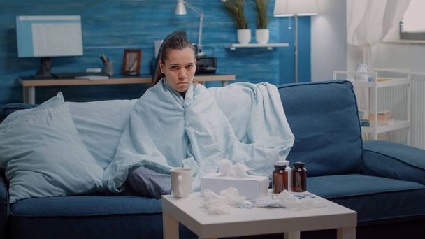 Kranke Frau mit Grippesymptomen blickt in Kamera - Foto, Bild