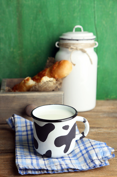 Retro still life with tasty rustic milk, on wooden table - Фото, изображение