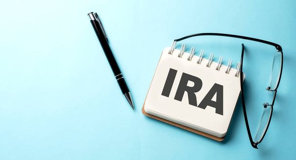 IRA text written on a notepad on blue background - Photo, Image