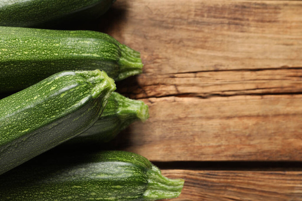 Raw ripe zucchinis on wooden table, closeup. Space for text - Foto, Bild