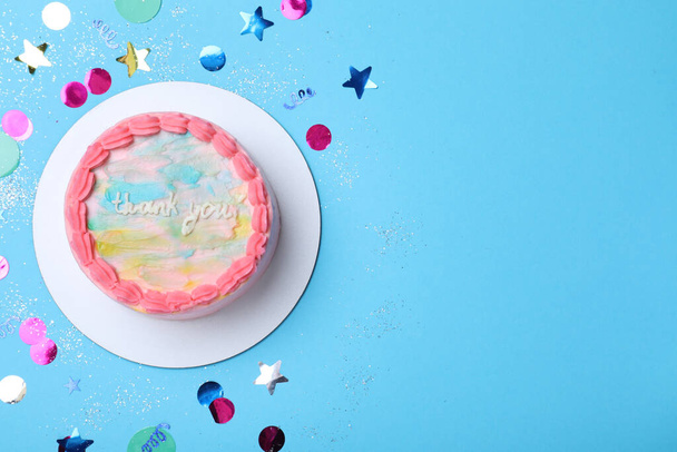 Cute bento cake with tasty cream and confetti on light blue background, flat lay. Space for text - Fotó, kép