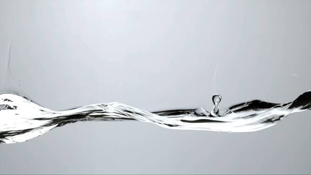 a drop of water falls on the surface - Foto, afbeelding