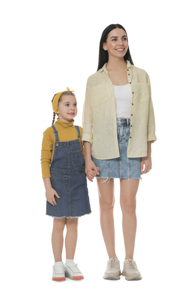Little girl with her mother on white background - Foto, imagen