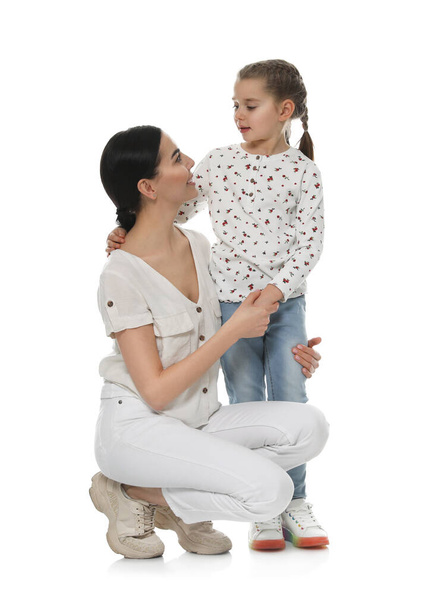 Little girl with her mother on white background - Φωτογραφία, εικόνα