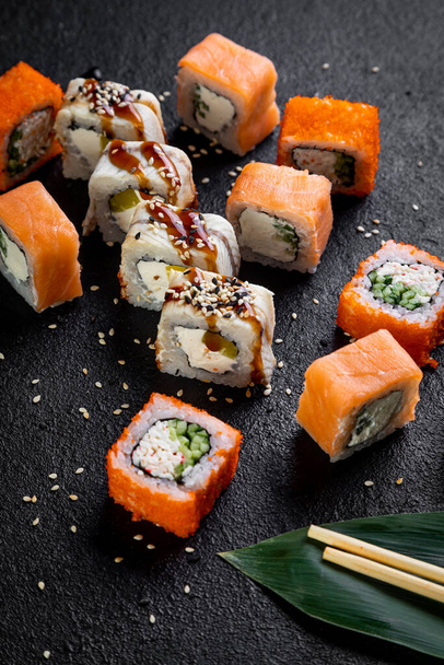 traditional japanese sushi dish, rolls. Sushi on a dark background - Photo, image