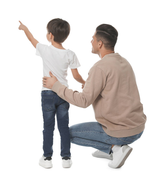 Little boy with his father on white background, back view - 写真・画像