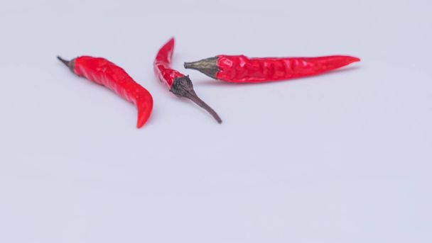 Close-up view of red hot chili peppers on white background. - Valokuva, kuva