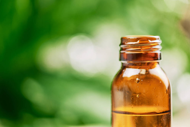 view of amber glass essential oil bottle - Фото, зображення