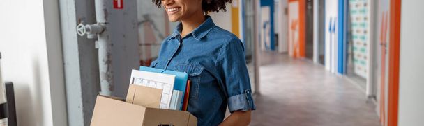 Happy female employer walking around the office with documents - 写真・画像