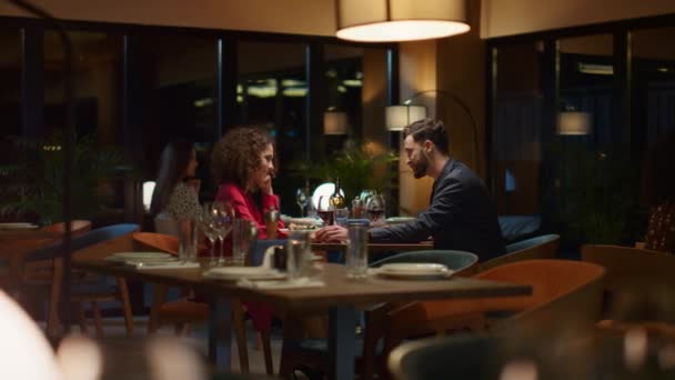 Elegante pareja sentada restaurante por la noche. Amantes de la raza mixta citas en la cafetería. - Imágenes, Vídeo