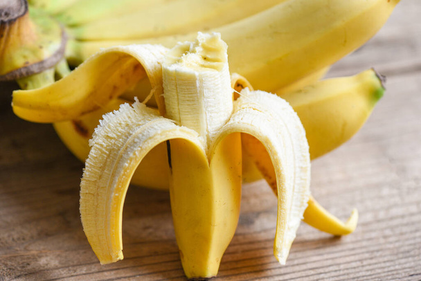 banana peel on wooden background, Close up ripe banana peel on floor - Photo, Image