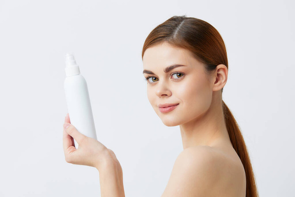 beautiful woman  with body lotion on  light background. High quality photo - Foto, imagen