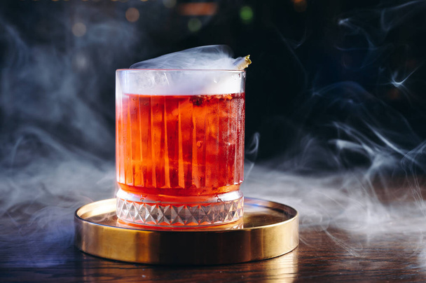 Classic old fashioned Cocktail in a retro glass with smoke - Фото, изображение