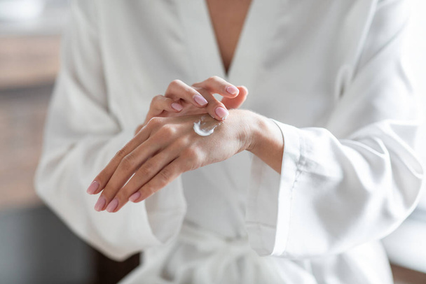 Closeup Shot Of Unrecognizable Female Using Moisturising Cream For Hands At Home - Photo, Image