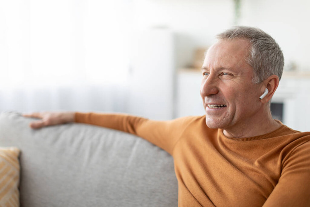 Calm mature man having rest at home listening to music - Photo, Image