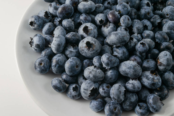fresh blueberries in a bowl on a white background - Fotó, kép