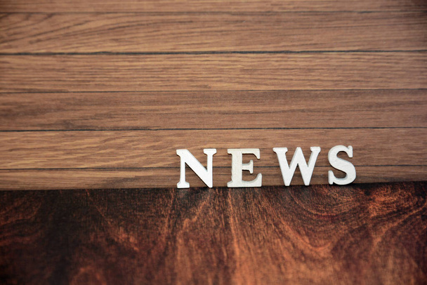 word news on wood background - Фото, изображение
