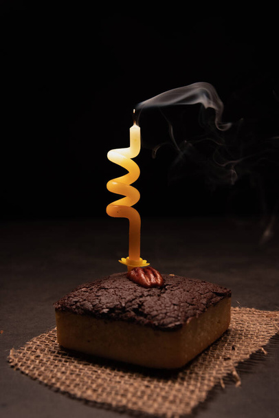 chocolate cake with caramel and nuts on a dark background - Valokuva, kuva