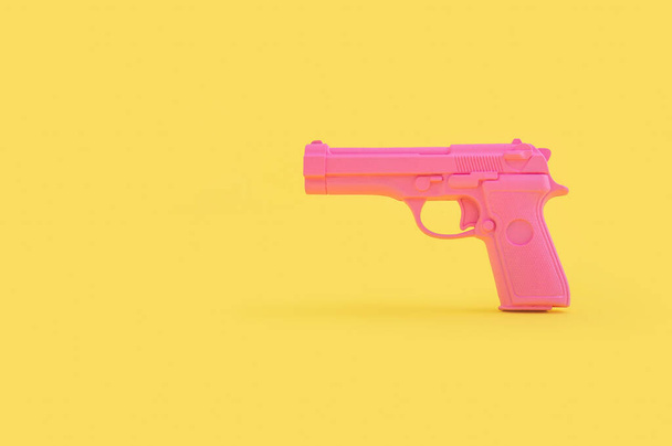 gun on yellow background - Foto, Imagen