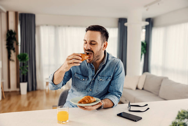 A man having breakfast at his cozy home. - Fotó, kép