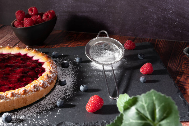 delicious fresh homemade cake with berries on dark background - Φωτογραφία, εικόνα