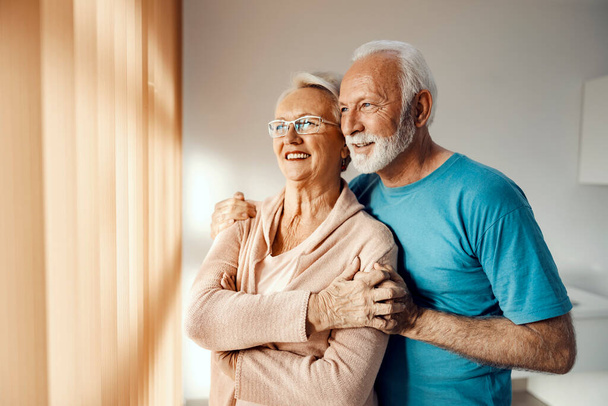 Una feliz pareja de ancianos abrazándose en un asilo. Cuidado de ancianos - Foto, imagen