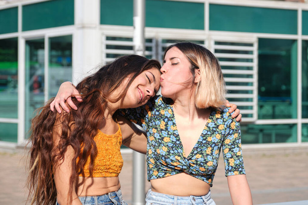 Jeune couple lesbienne, sur embrasse les autres front à l'extérieur. - Photo, image