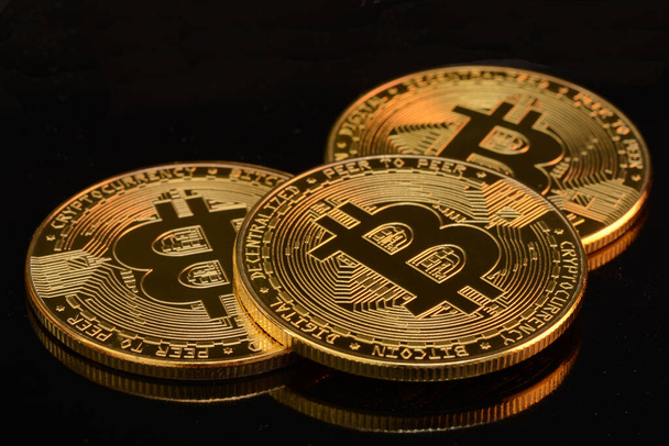 bitcoins on a black background, close up - Φωτογραφία, εικόνα