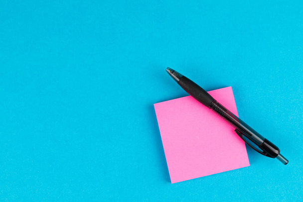 blank paper note with pen on blue background - Φωτογραφία, εικόνα
