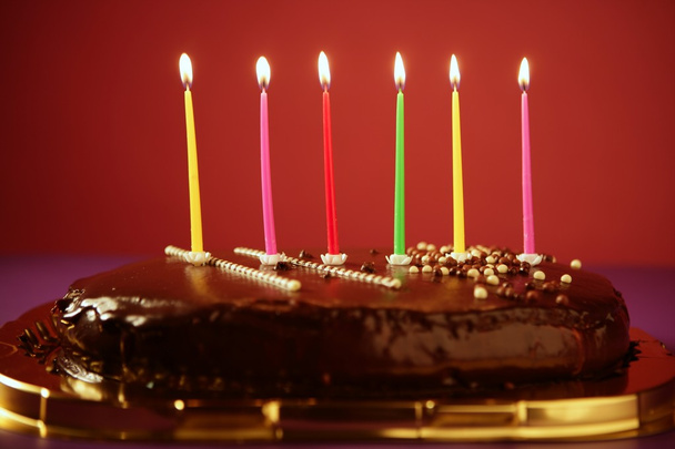 Colorful birthday light candles in chocolate cake - Fotografie, Obrázek