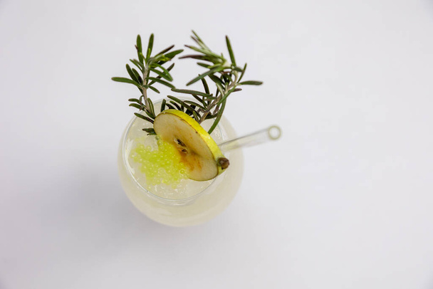 glass of fresh lemonade with lemon and rosemary on white background - Fotoğraf, Görsel