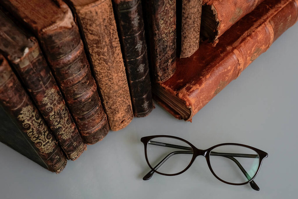 old books and glasses on a wooden background - Фото, зображення