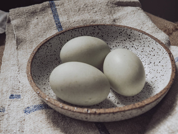 eggs in a white bowl on table - Zdjęcie, obraz