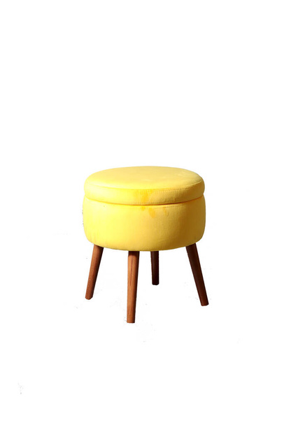 Soft yellow ottoman on four wooden legs - Фото, изображение
