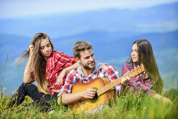 Camping together is fun. friendship. romantic picnic in tourism camp. campfire songs. group of people spend free time together. family camping. hiking adventure. happy men and girls with guitar - Photo, Image