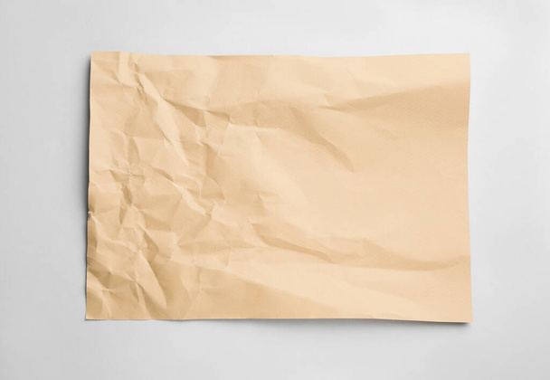 Sheet of crumpled brown paper on white background, top view - Foto, Imagen
