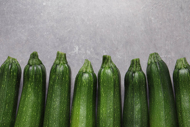 Raw ripe zucchinis on light grey table, flat lay. Space for text - Photo, Image