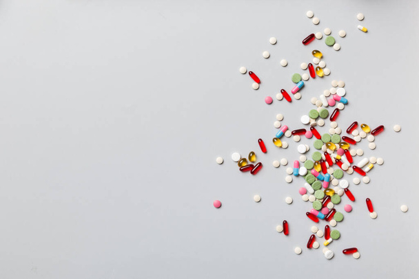 assorted pills and tablets top border over colored background. Many different pills and space for text on colorful background, top view. - 写真・画像