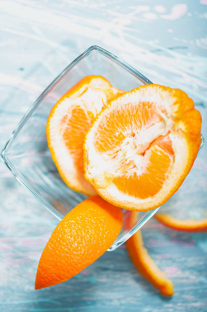 fresh orange and slices of grapefruit on a blue background - Фото, зображення