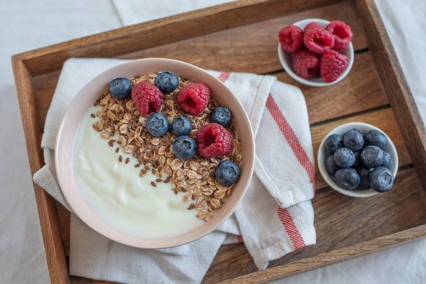 healthy breakfast with granola and berries on wooden table - Fotografie, Obrázek