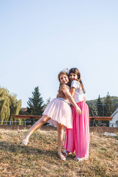 Two cute, little girls hugging. Childhood friendship - Fotoğraf, Görsel