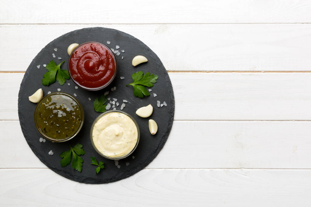 Many different sauces and herbs on table, flat lay top view. sauces on plate, healthy concept. - 写真・画像