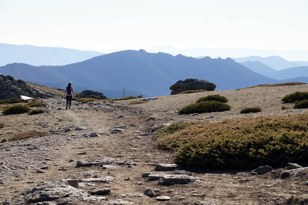 a man in a white jacket is hiking in the mountains - Photo, Image