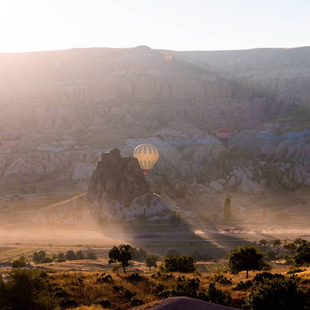 Cappadocia Sunrise. Sunrise in Cappadocia with hot air balloons on the sky. Hot air balloon tour in Goreme.  - Photo, image