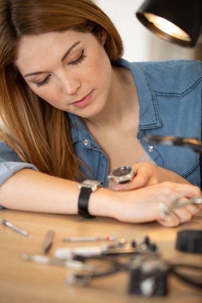 young woman looking wrist watch repairing - Фото, зображення