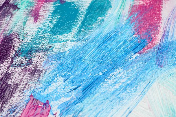Strokes of colorful acrylic paints on white canvas, closeup - 写真・画像
