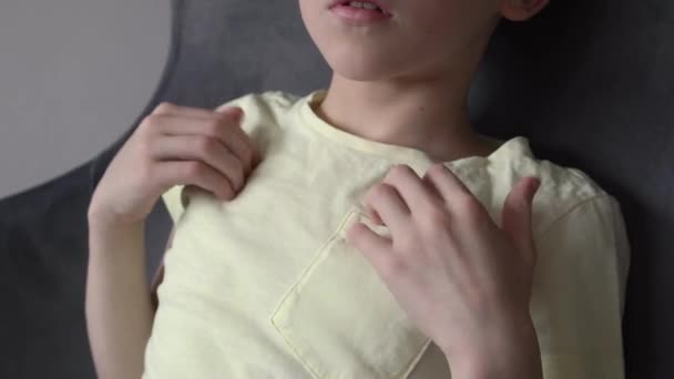 Little boy practicing EFT or emotional freedom technique - tapping on the collarbone point, at home - Footage, Video